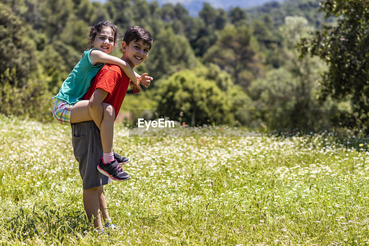 Full length of boy standing on grass