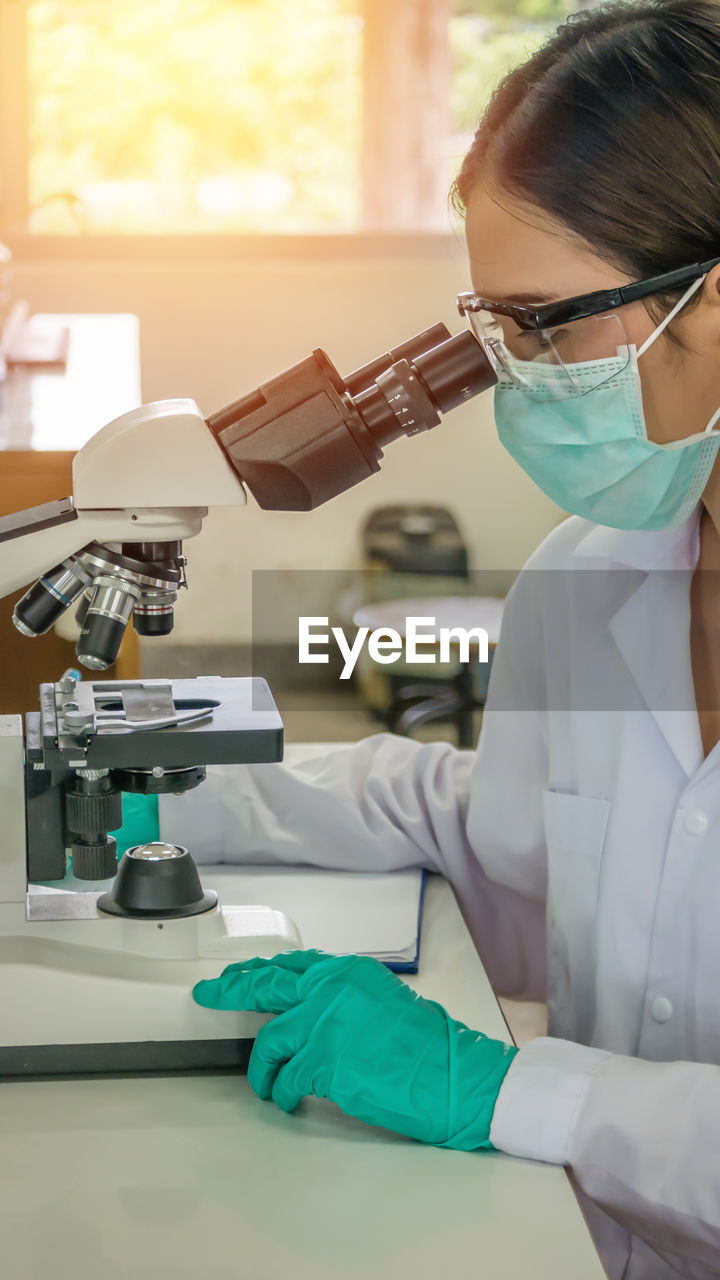 Close-up of scientist examining in laboratory