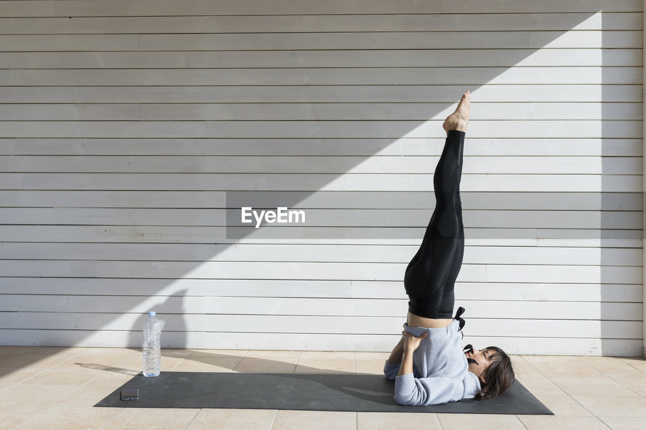 Chinese young woman doing yoga exercise in the sun