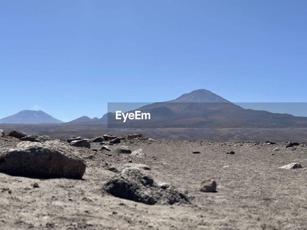 mountain, landscape, scenics - nature, sky, environment, natural environment, land, volcano, nature, beauty in nature, no people, non-urban scene, plateau, clear sky, wilderness, geology, volcanic landscape, desert, day, blue, tranquil scene, tranquility, travel destinations, ridge, mountain range, travel, outdoors, sunny, physical geography, climate, arid climate, remote, copy space, animal wildlife