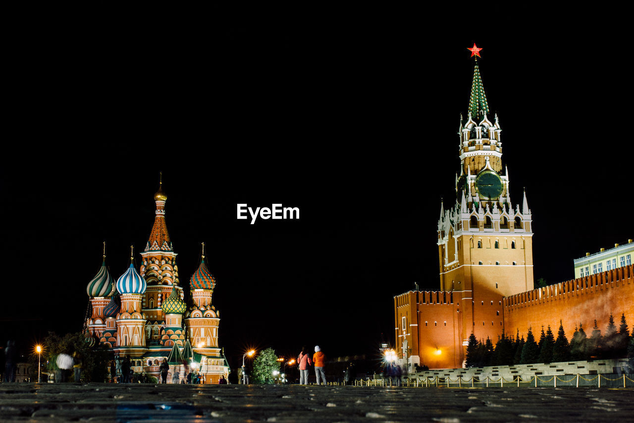 Illuminated historic buildings at red square in moscow kremlin against sky at night