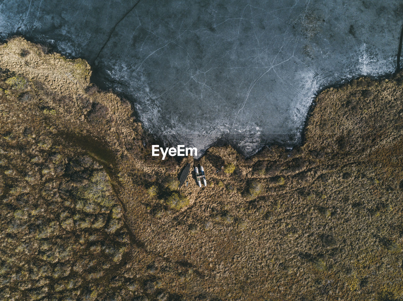 Aerial view of land by sea