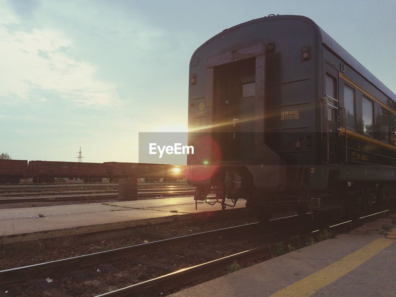 Train on platform at sunset