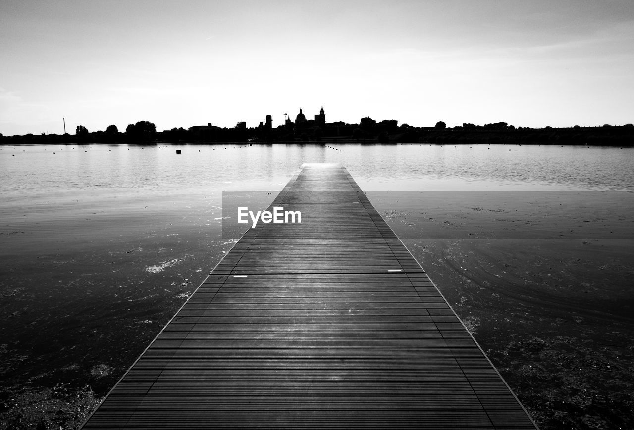 Pier over lake against sky