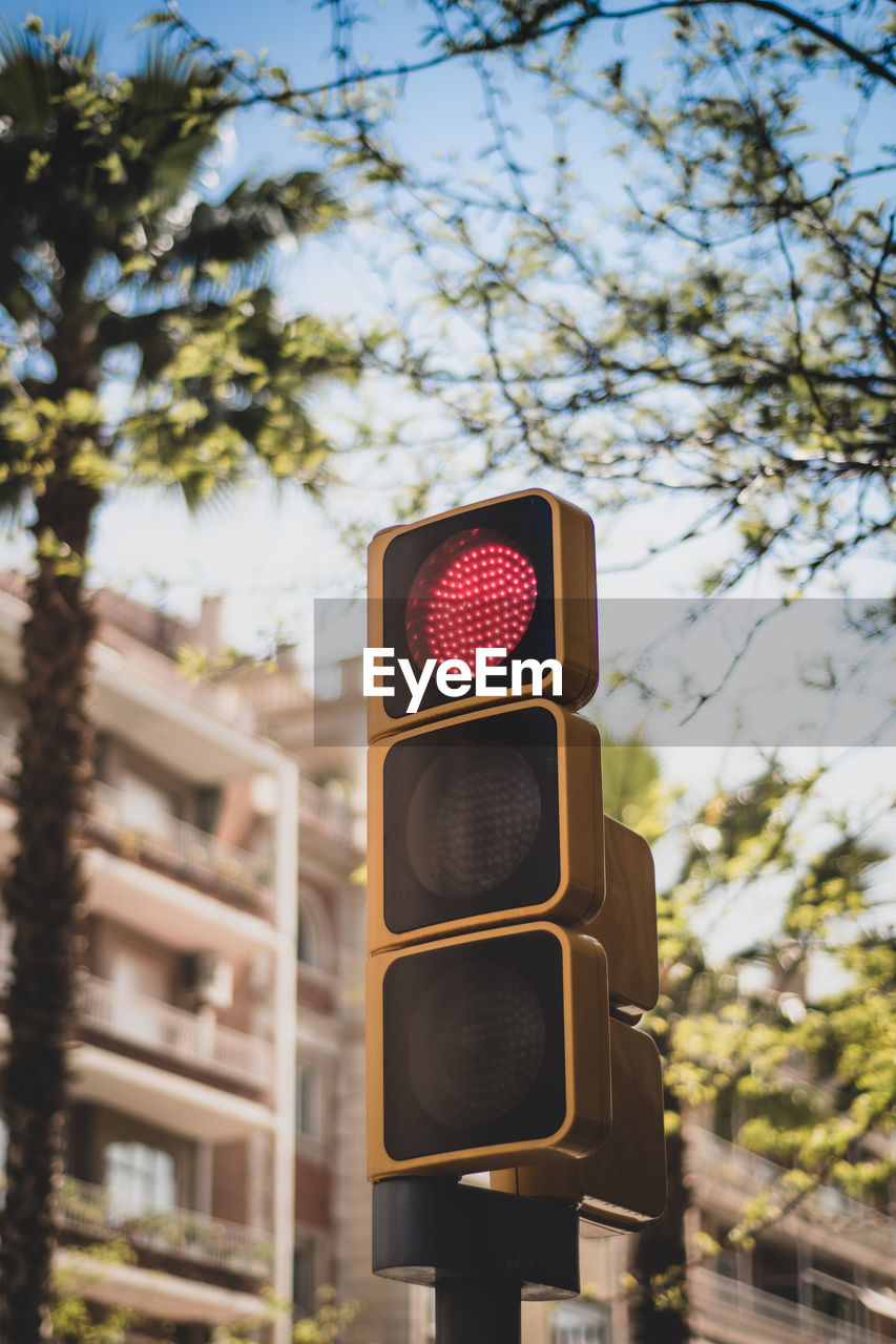 Low angle view of traffic lights   against sky