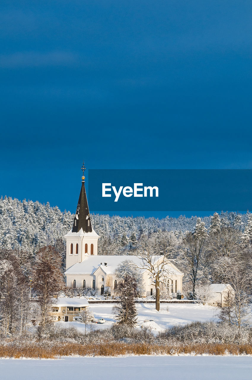 low angle view of church against blue sky