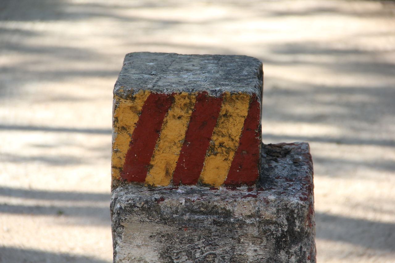 Close-up of rusty metal on wooden post