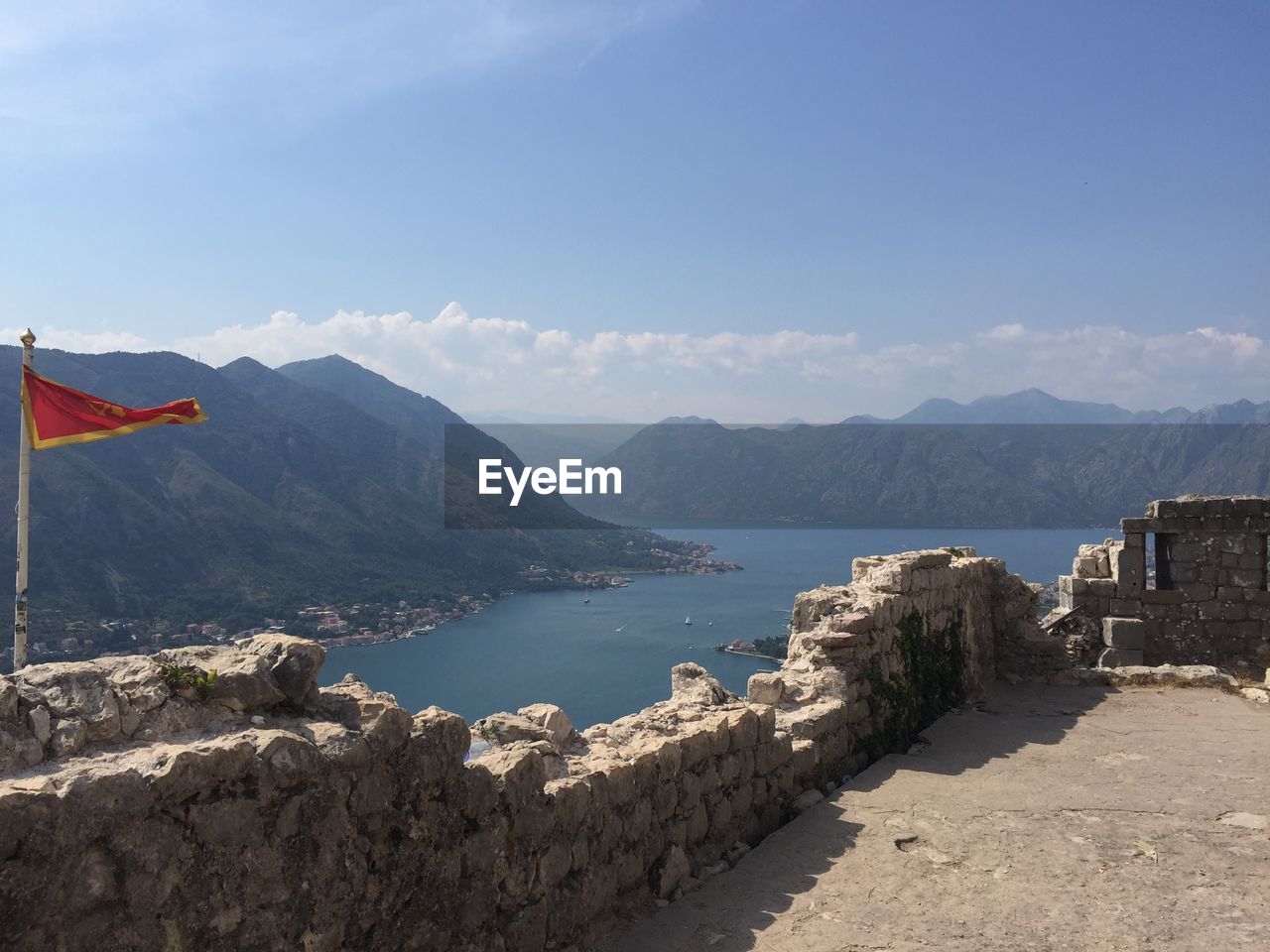 Scenic view of sea and mountains against sky