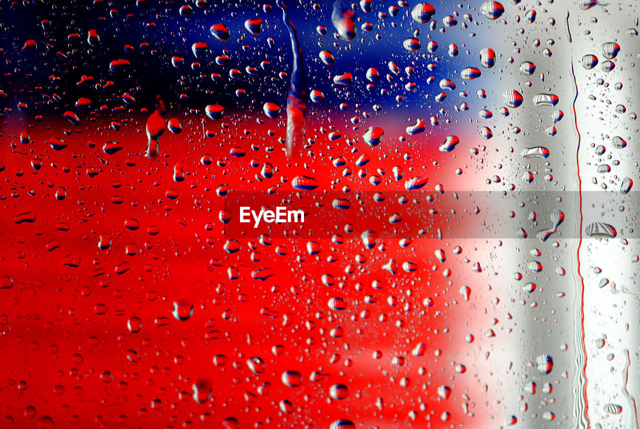 Full frame shot of wet car window glass