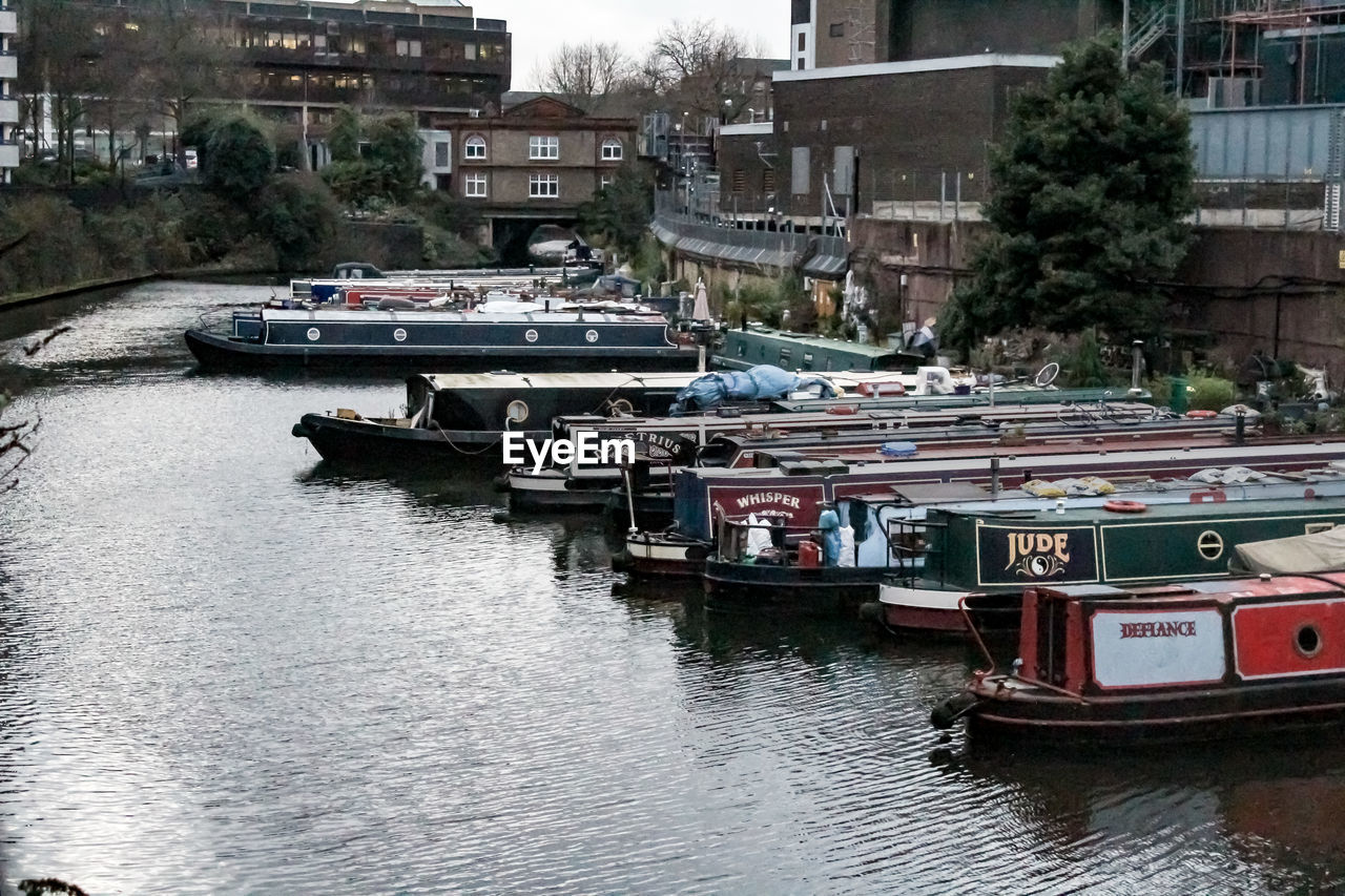 BOATS MOORED IN RIVER BY CITY