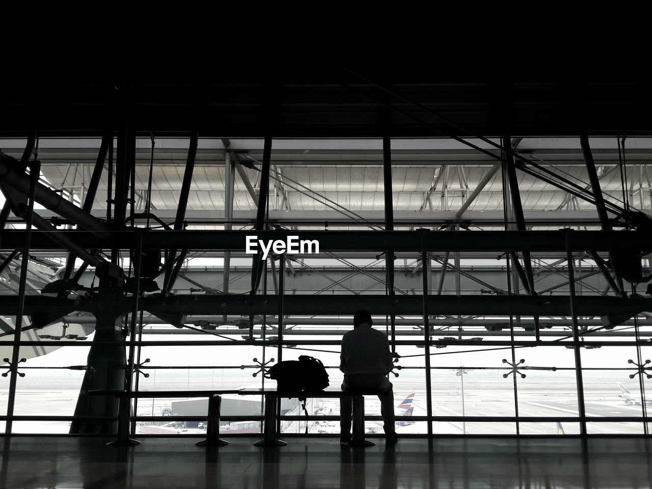 REAR VIEW OF A SILHOUETTE MAN IN A ROOM