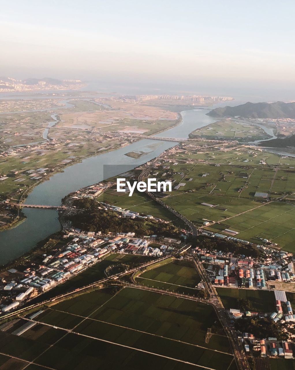 High angle view of river amidst buildings in city against sky