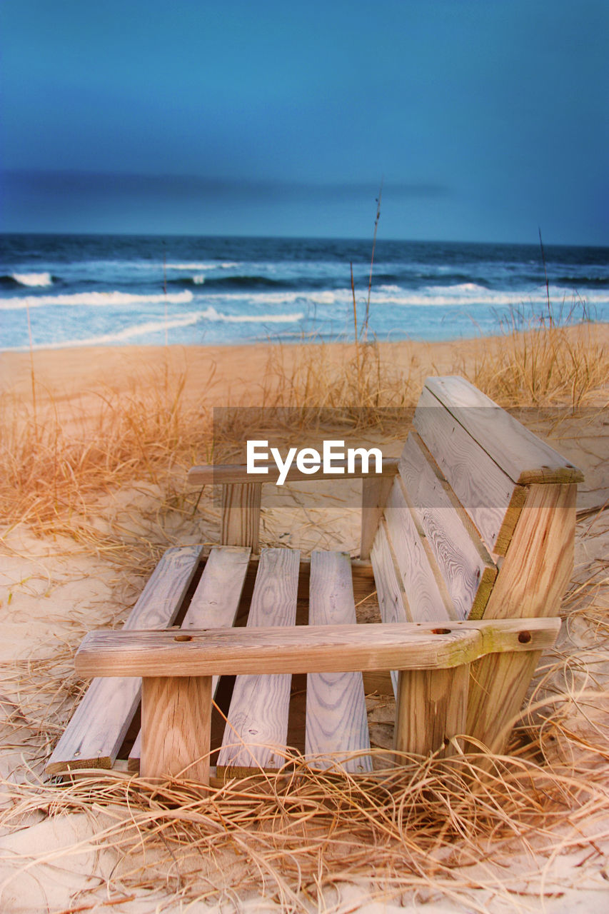 CHAIRS ON BEACH AGAINST SKY