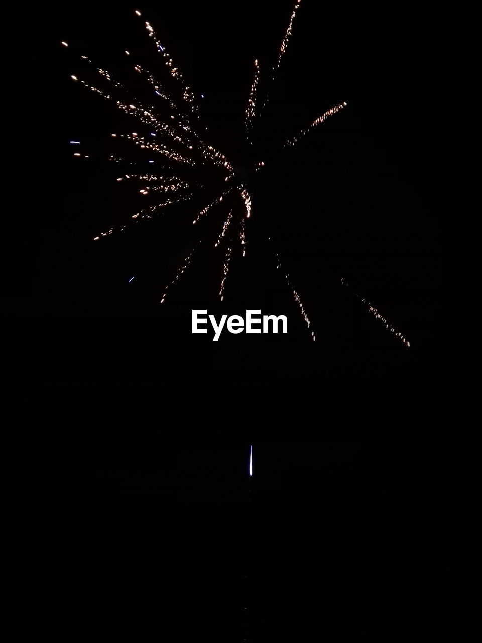 LOW ANGLE VIEW OF FIREWORK DISPLAY AT NIGHT