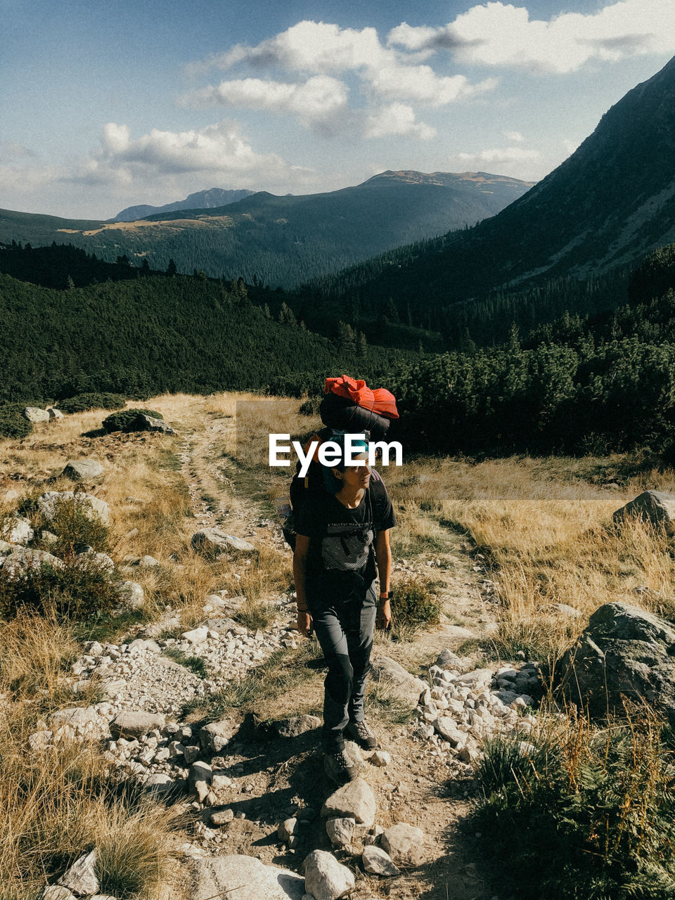 Girl standing on mountain against sky