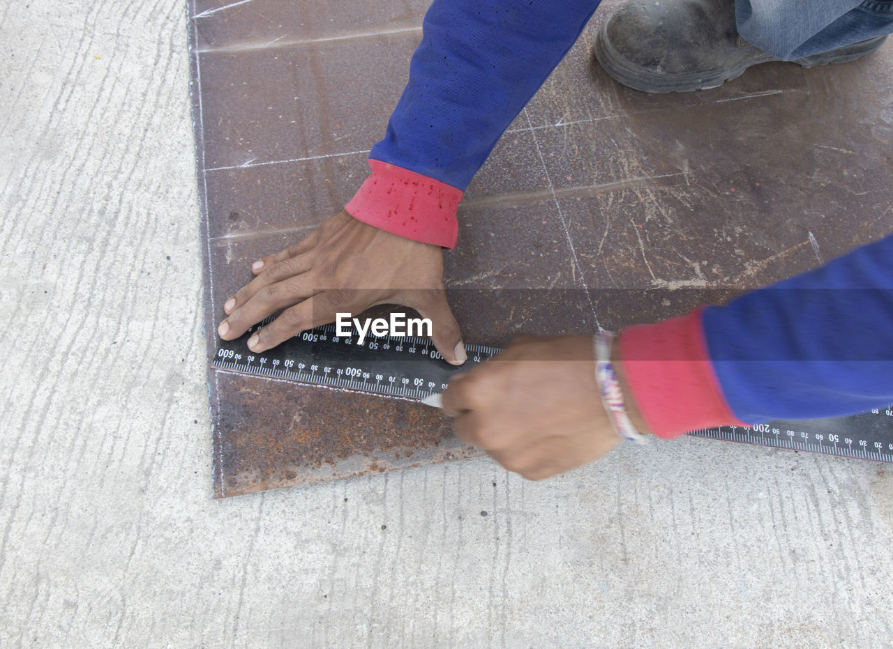 LOW SECTION OF WOMAN WORKING ON WOOD FLOOR