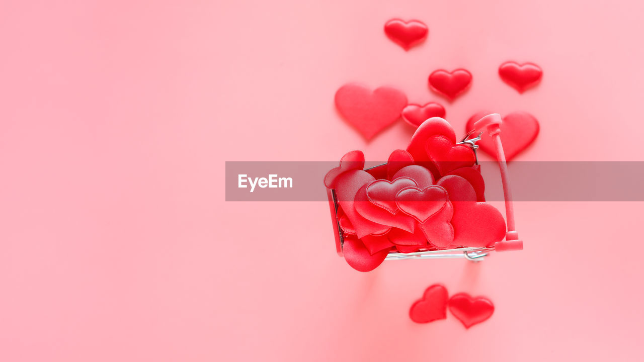 HIGH ANGLE VIEW OF HEART SHAPE OVER PINK BACKGROUND