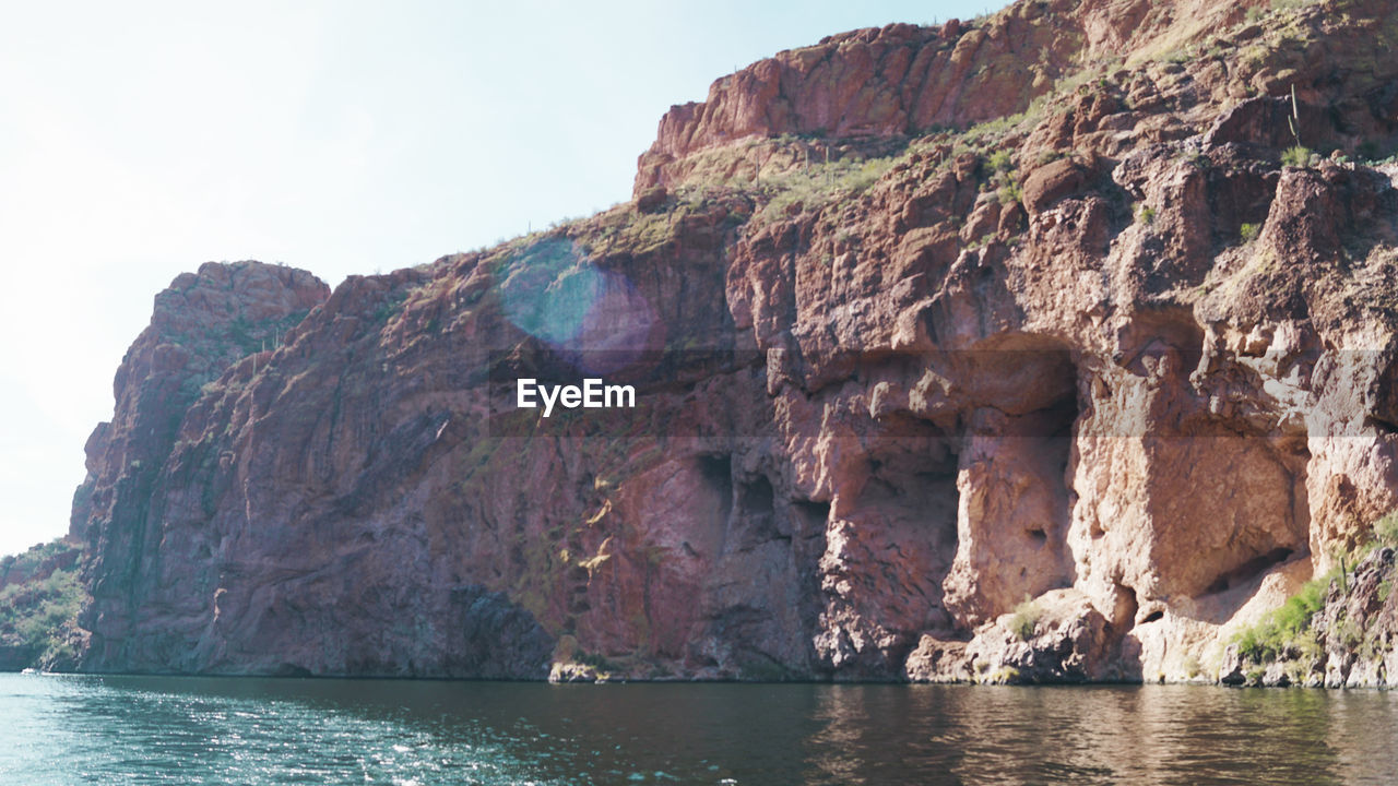 SCENIC VIEW OF ROCK FORMATIONS IN SEA