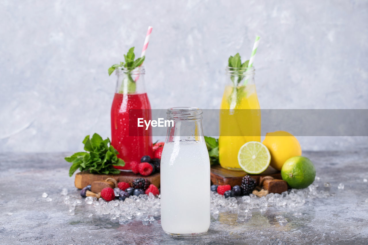 Fruits juices in glass jar on table