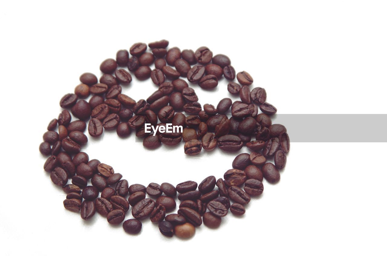 CLOSE-UP OF HEART SHAPE MADE OF COFFEE BEANS