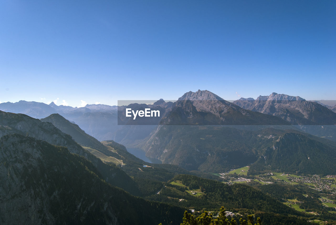 Scenic view of mountains against clear blue sky