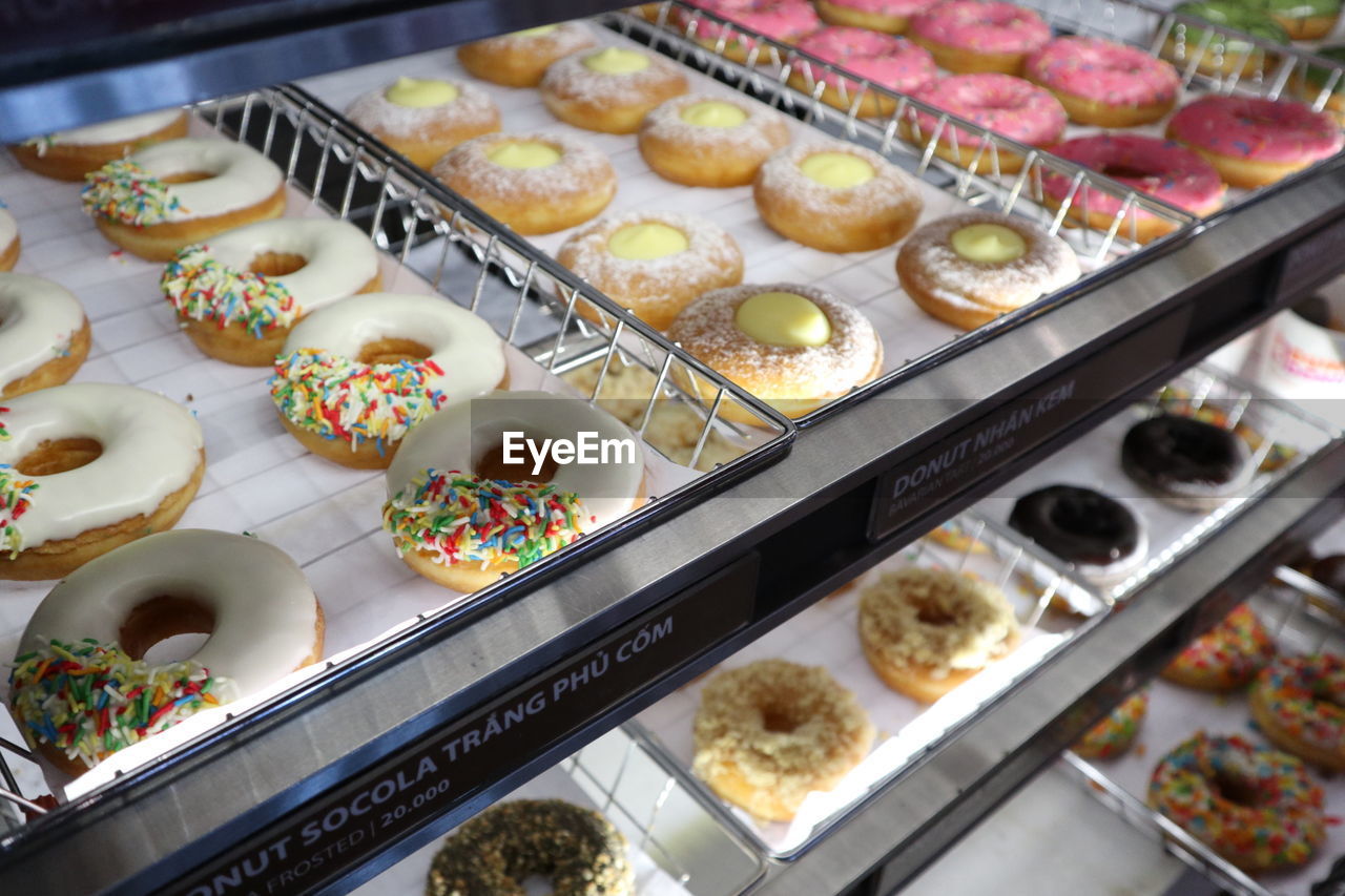 Donuts in display cabinet for sale at store