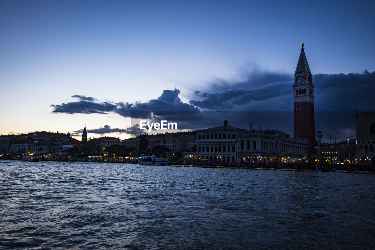 Doges palace - venice and st marks square by san marco canal against sky during sunset