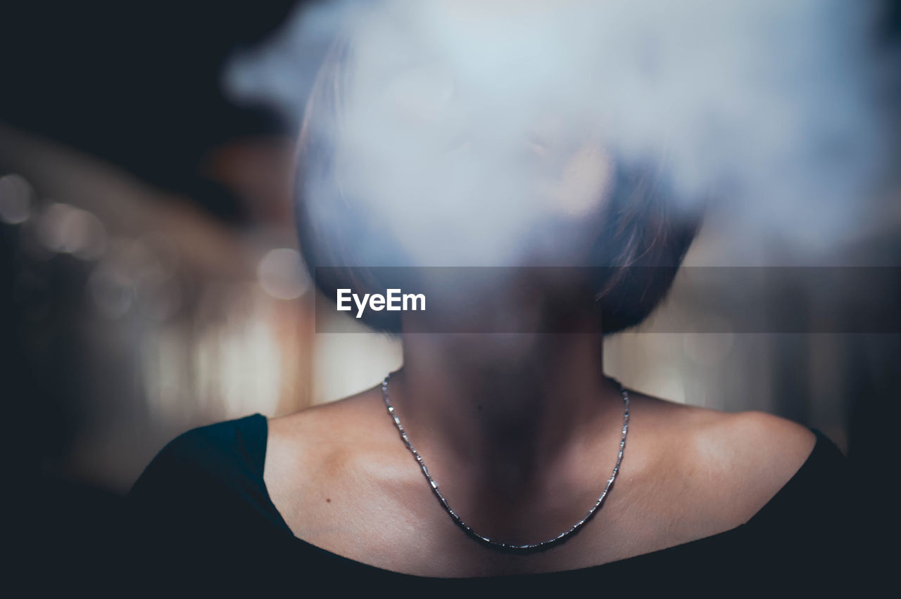 Close-up of woman exhaling smoke