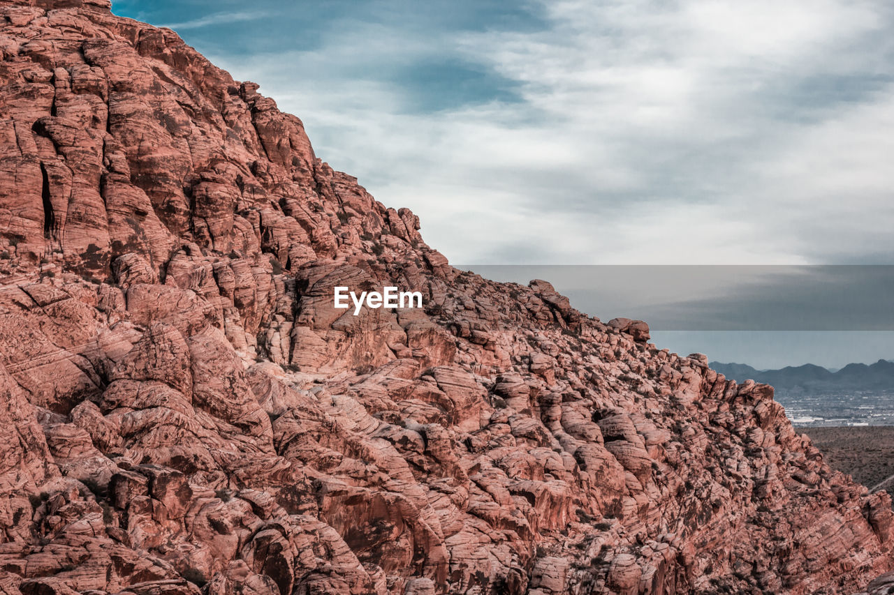 LOW ANGLE VIEW OF ROCKY MOUNTAIN AGAINST SKY