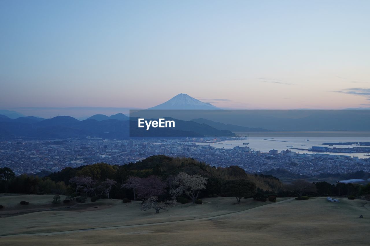 SCENIC VIEW OF LANDSCAPE AND MOUNTAINS AGAINST SKY