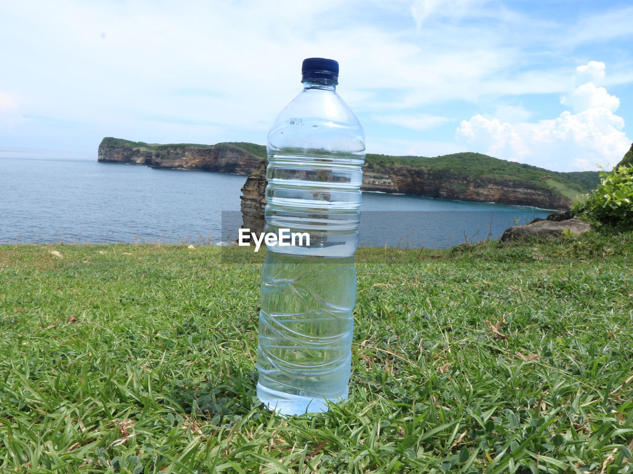 WATER BOTTLE ON SEA SHORE