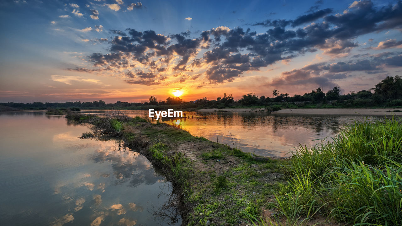 Scenic view of lake against sky during sunset