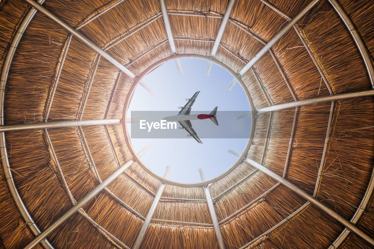 Low angle view circular shaped roof with the plane that is blurred in the middle