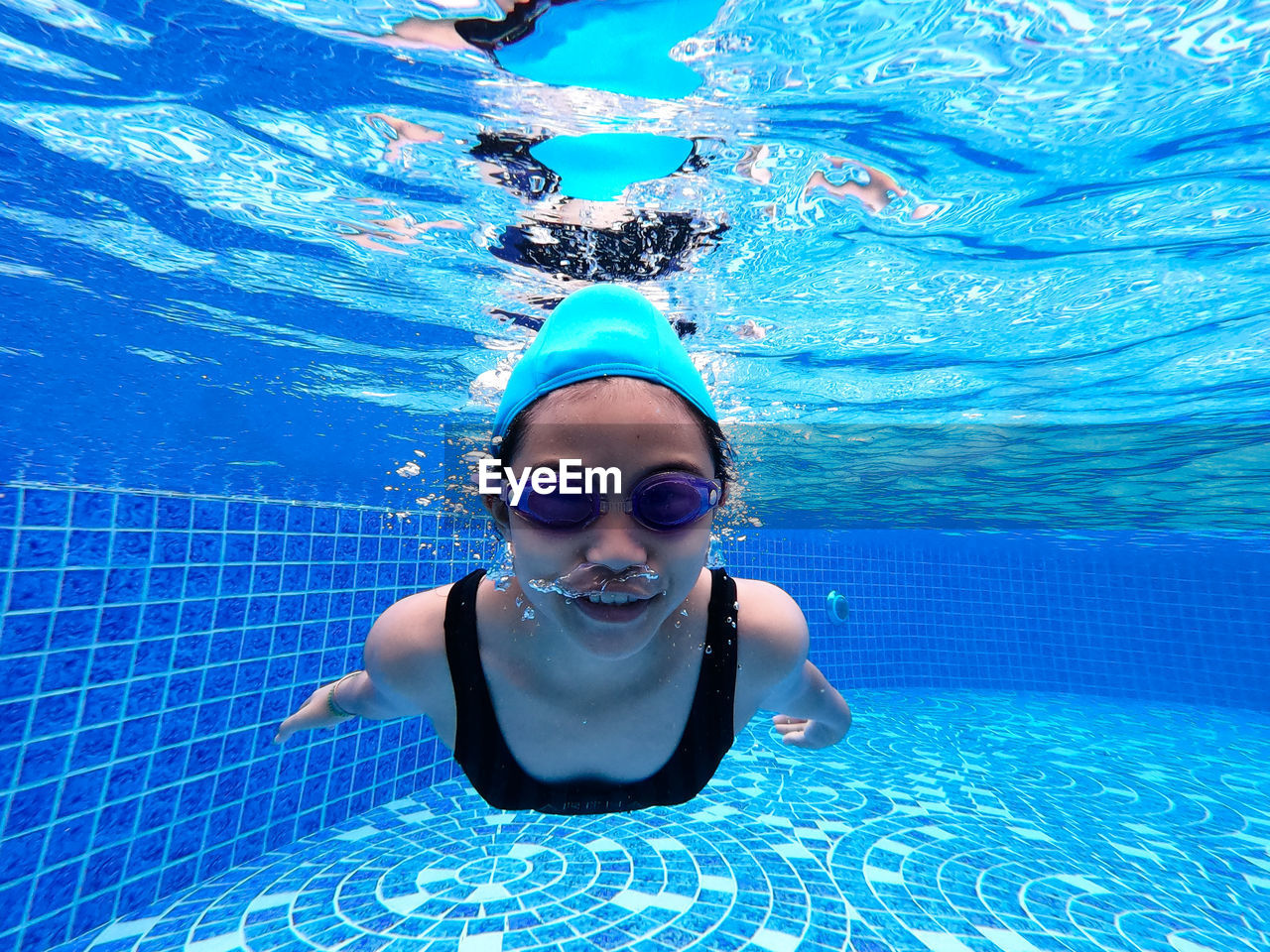 Portrait of girl swimming in pool