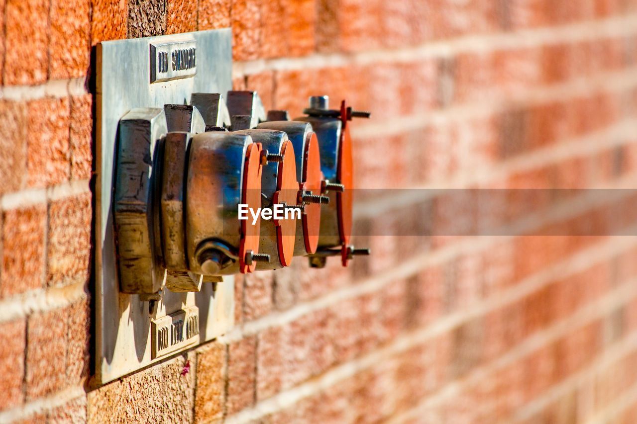 Close-up of pipe on brick wall