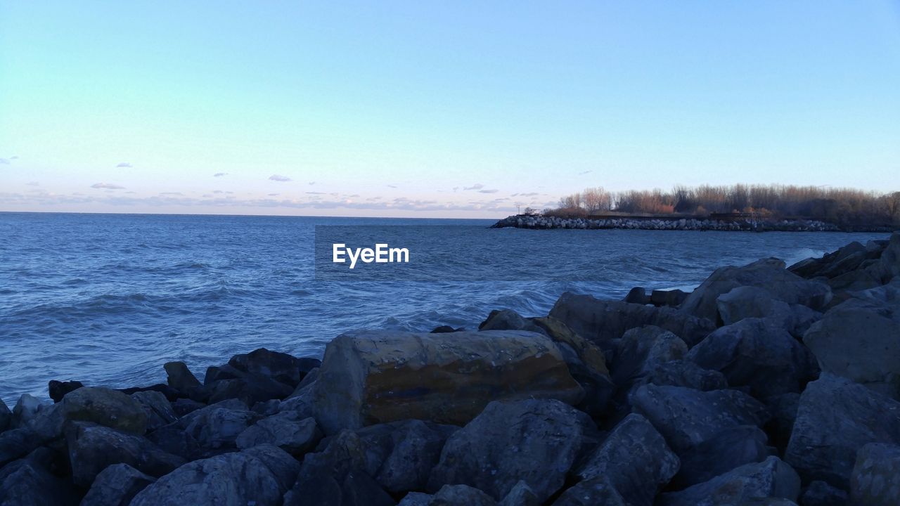 SCENIC VIEW OF SEA WITH ROCKS IN BACKGROUND