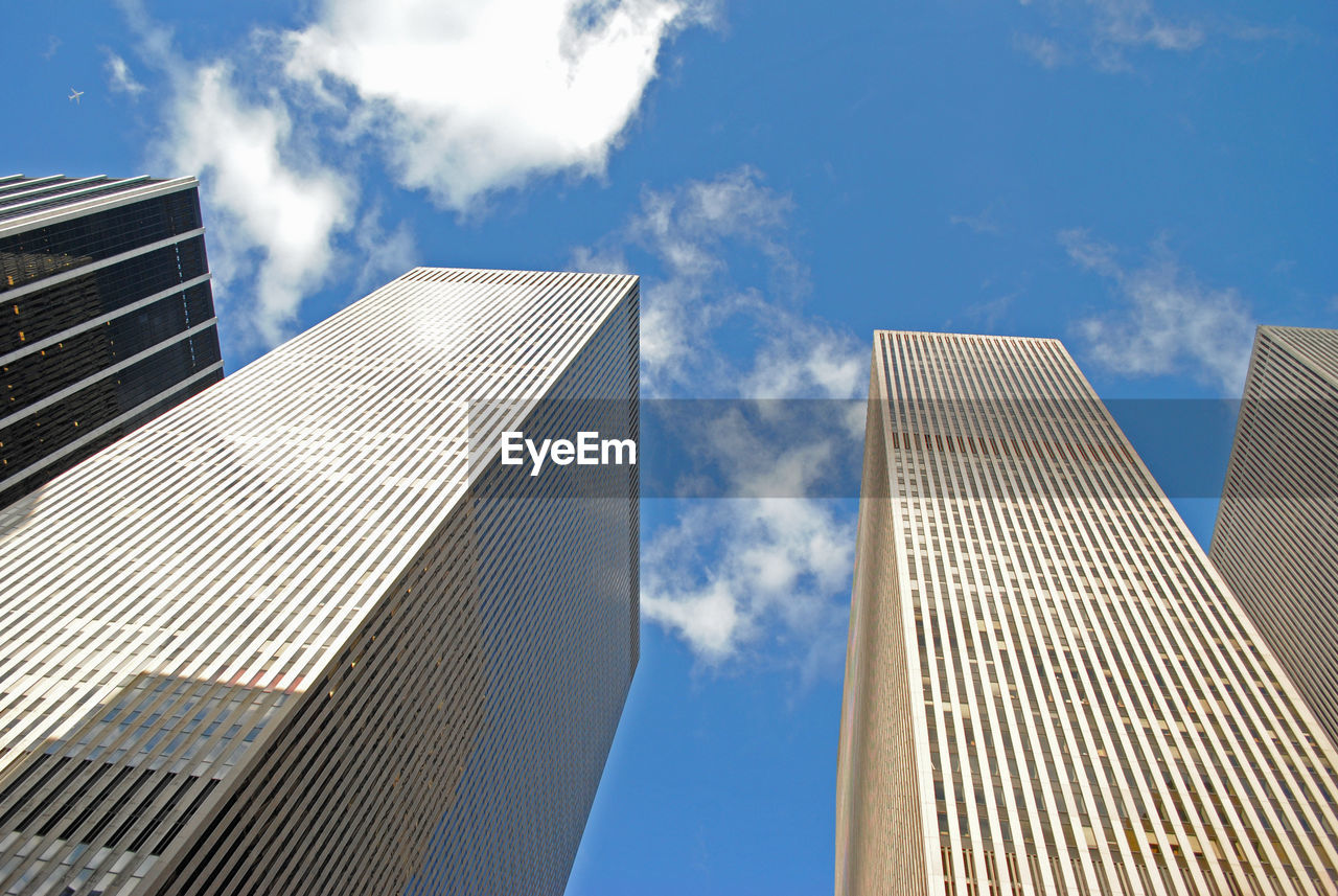 Low angle view of modern buildings against sky in city