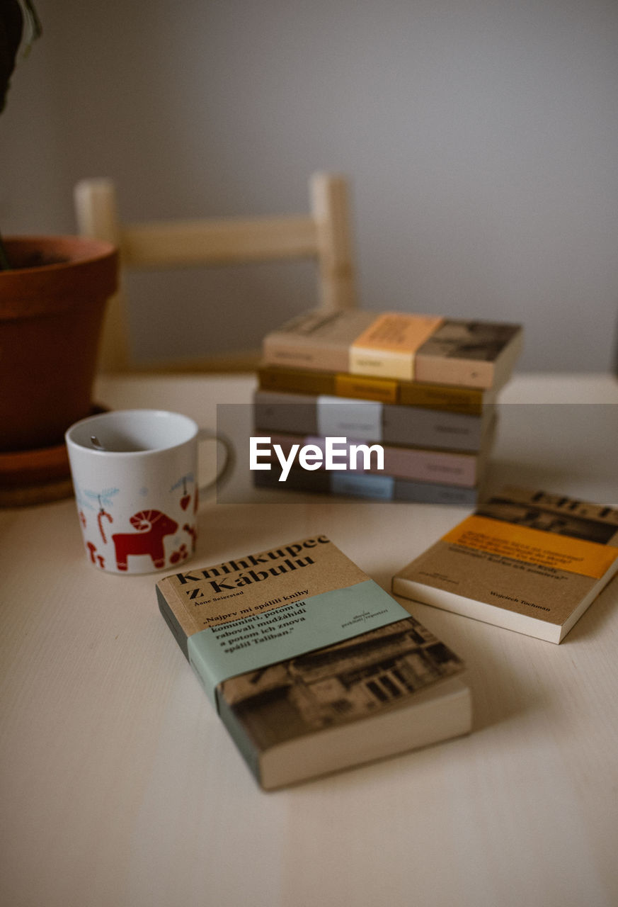 CLOSE-UP OF COFFEE CUP ON TABLE AT HOME