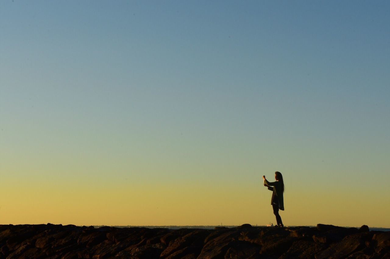 WOMAN STANDING ON LANDSCAPE