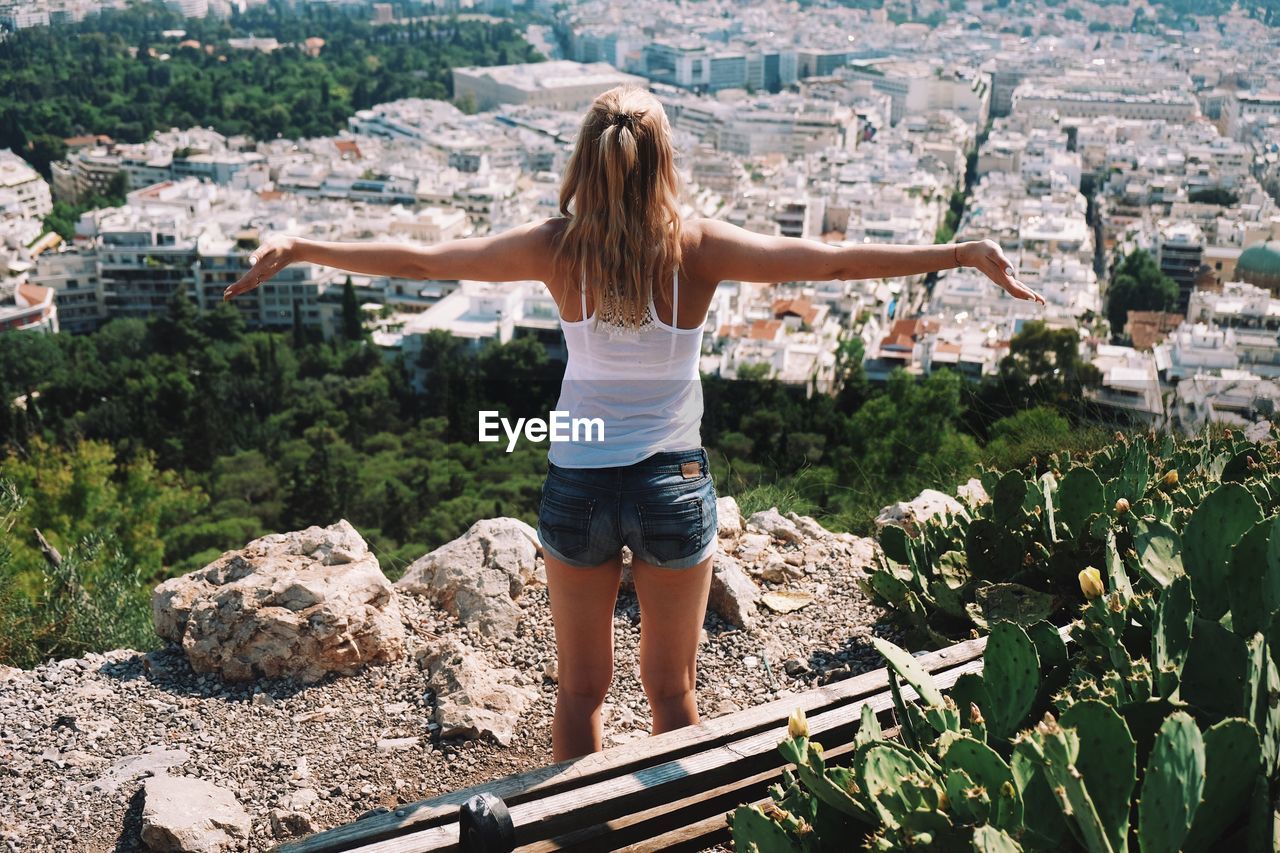 Rear view of woman standing against cityscape