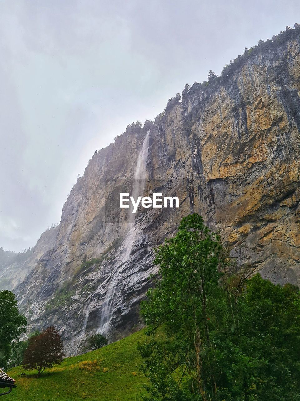 Low angle view of waterfall against sky