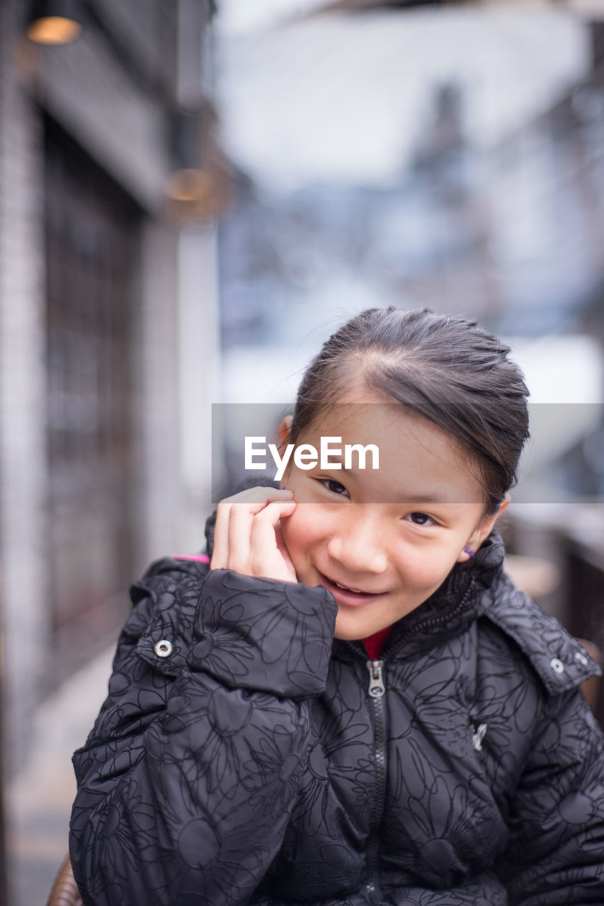 Portrait of smiling girl wearing warm clothing