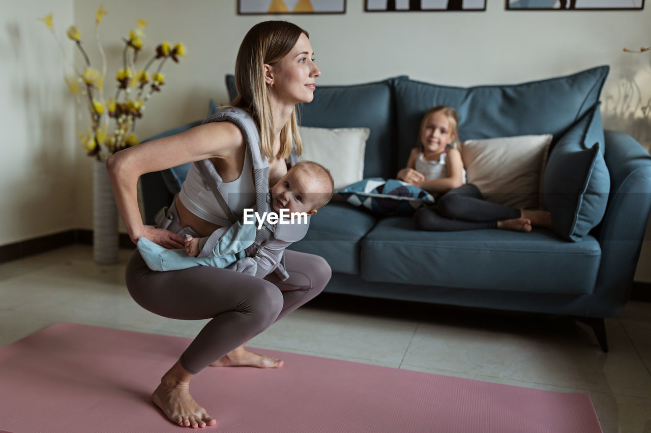 YOUNG COUPLE SITTING ON SOFA AT HOME