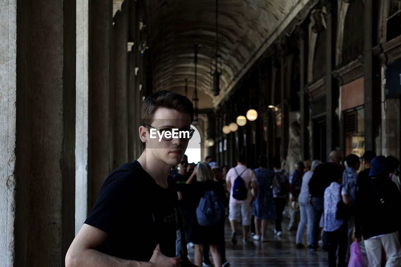 PORTRAIT OF YOUNG MAN IN SUNGLASSES