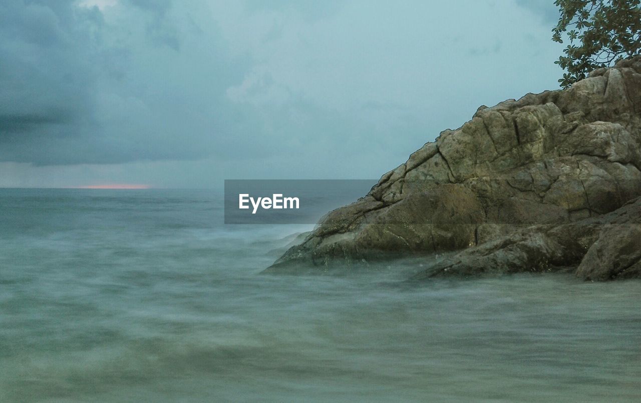 Scenic view of sea against cloudy sky