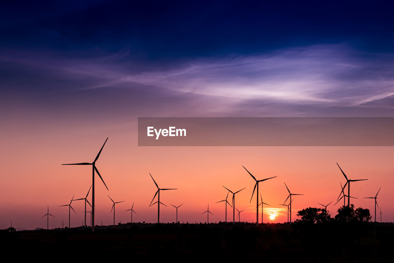 SILHOUETTE OF WIND TURBINES ON LAND