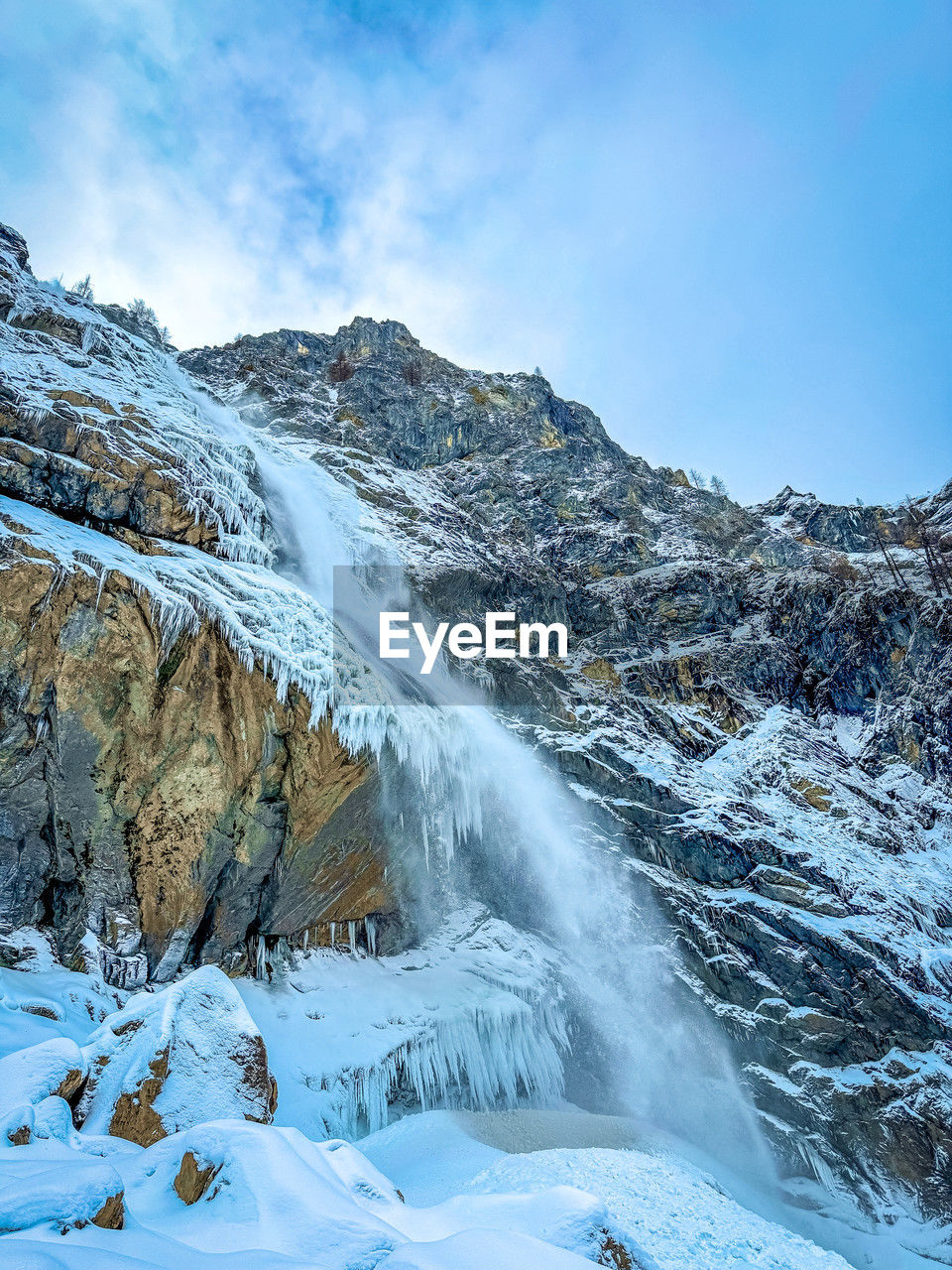 cold temperature, snow, scenics - nature, environment, winter, landscape, beauty in nature, mountain, sky, nature, mountain range, travel destinations, travel, ice, blue, water, cloud, frozen, land, no people, tourism, outdoors, non-urban scene, snowcapped mountain, glacial landform, forest, waterfall, tree, ridge, tranquil scene, tranquility, day, rock, motion, glacier, white, mountain peak, fog, polar climate, coniferous tree, idyllic