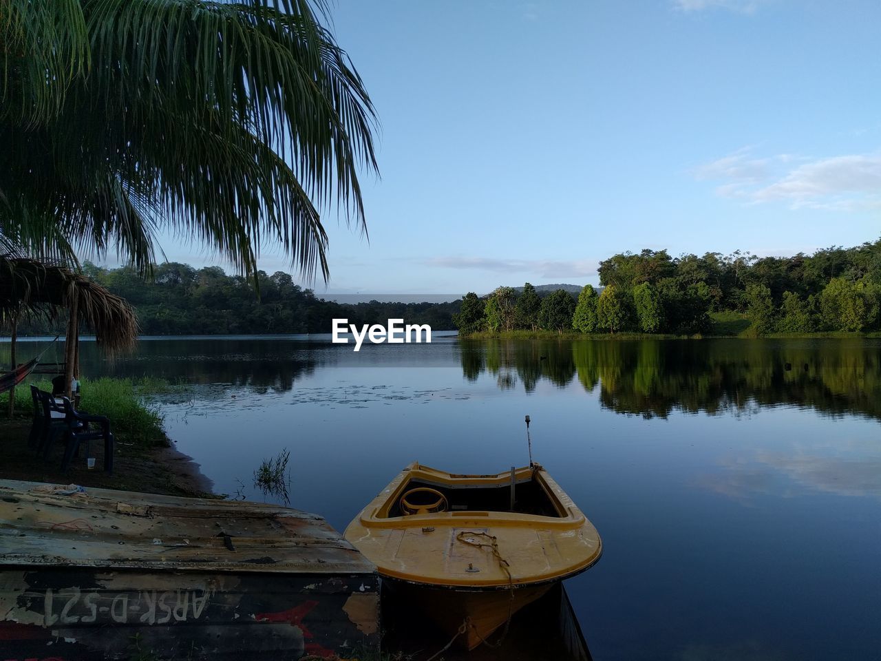 Reflection of trees in lake against sky