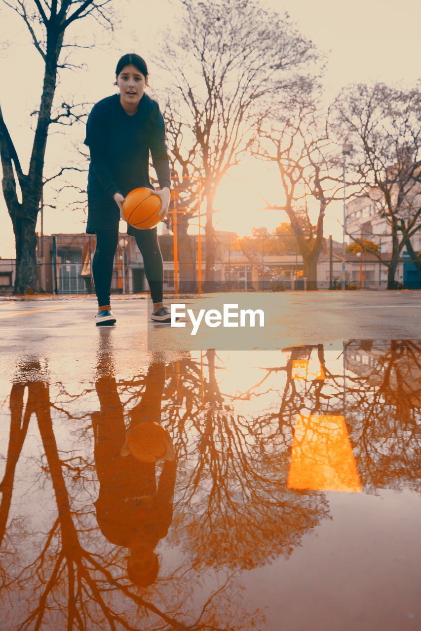 Female basketball player during rainy day