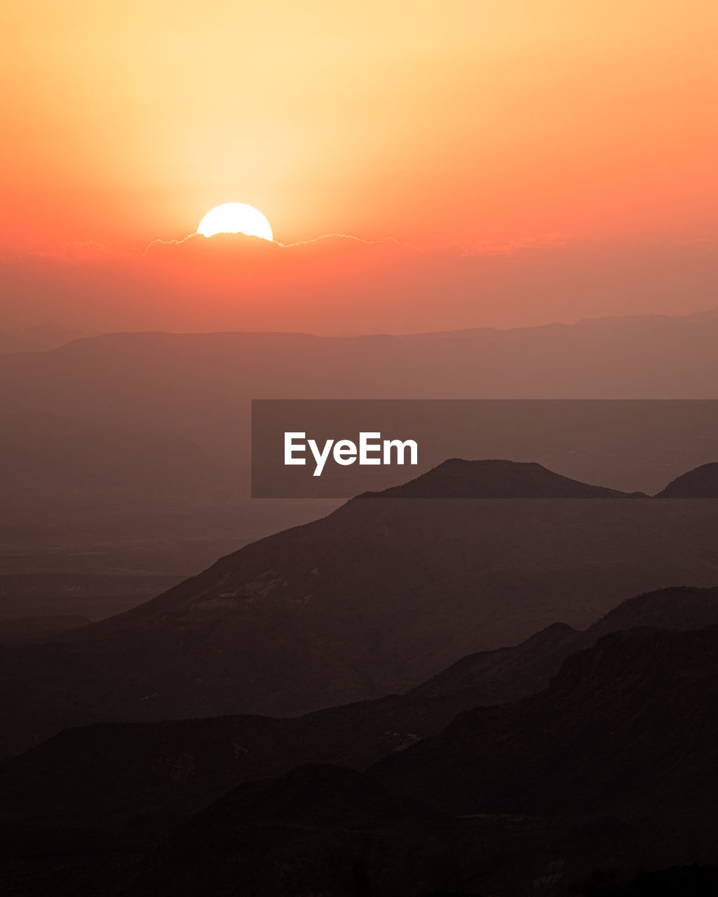 Scenic view of silhouette mountains against sky during sunset